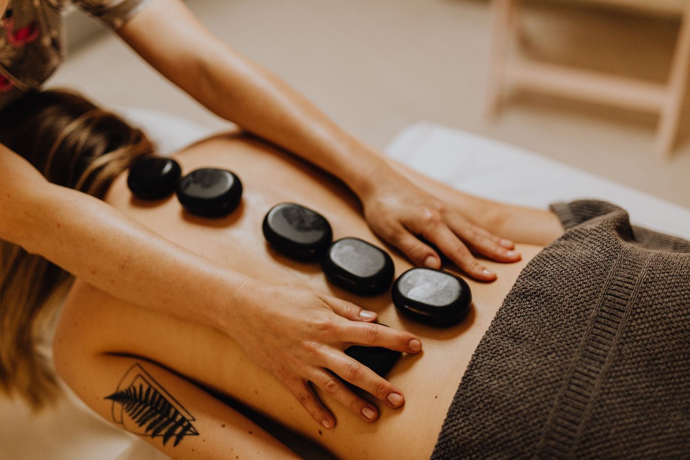 Smooth basalt stones placed on the back during hot stone therapy